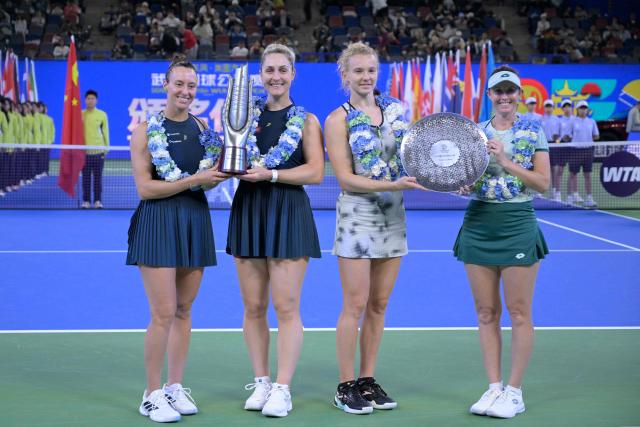 Brazil’s Luisa Stefani and Canada’s Gabriela Dabrowski pose with runners-up Czech Republic’s Katerina Siniakova and Australia's Storm Hunter during the trophy ceremony in the women’s doubles final match at the Wuhan Open tennis tournament in Wuhan, China's Hubei province on October 18, 2026. (Photo by WANG Zhao / AFP)