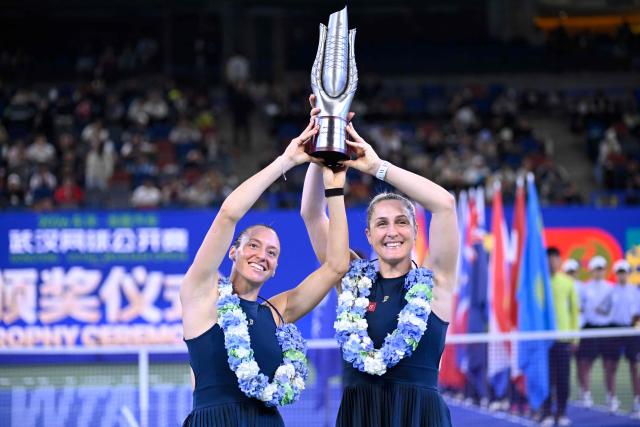 Brazil’s Luisa Stefani (L) and Canada’s Gabriela Dabrowski celebrate with the trophy after beating Czech Republic’s Katerina Siniakova and Australia's Storm Hunter in the women’s doubles final match at the Wuhan Open tennis tournament in Wuhan, China's Hubei province on October 18, 2026. (Photo by WANG Zhao / AFP)