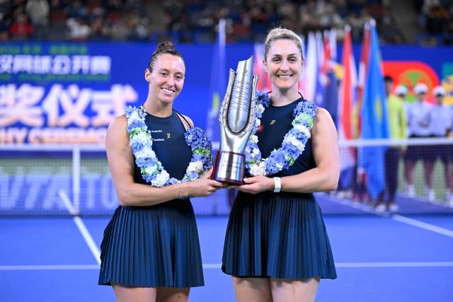 Brazil’s Luisa Stefani (R) and Canada’s Gabriela Dabrowski celebrate with the trophy after beating Czech Republic’s Katerina Siniakova and Australia's Storm Hunter in the women’s doubles final match at the Wuhan Open tennis tournament in Wuhan, China's Hubei province on October 18, 2026. (Photo by WANG Zhao / AFP)