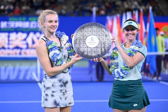 Runners-up Czech Republic’s Katerina Siniakova and Australia's Storm Hunter pose with the trophy after the women’s doubles final match against Brazil’s Luisa Stefani and Canada’s Gabriela Dabrowski at the Wuhan Open tennis tournament in Wuhan, China's Hubei province on October 18, 2026. (Photo by WANG Zhao / AFP)
