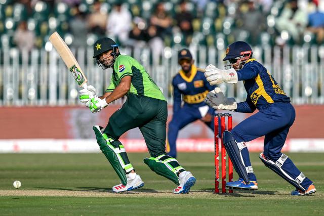 Pakistan's Hasan Nawaz (L) watches the ball after playing a shot during the tri-series one-day international (ODI) cricket match between Pakistan and Sri Lanka at the Rawalpindi Cricket Stadium in Rawalpindi on October 18, 2026. (Photo by Aamir QURESHI / AFP)