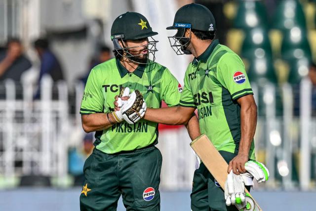 Pakistan's Salman Agha (L) celebrates with teammate Hasan Nawaz after scoring a half-century (50 runs) during the tri-series one-day international (ODI) cricket match between Pakistan and Sri Lanka at the Rawalpindi Cricket Stadium in Rawalpindi on October 18, 2026. (Photo by Aamir QURESHI / AFP)