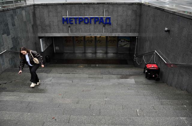 CORRECTION / A pedestrian walks up the stairs from an underground pedestrian passage and mall past a working power generator during an outage on October 18, 2026, caused by attacks on energy facilities in the country, amid the Russian invasion of Ukraine. (Photo by Sergei SUPINSKY / AFP) / “The erroneous mention[s] appearing in the metadata of this photo by Sergei SUPINSKY has been modified in AFP systems in the following manner: [October 18, 2026] instead of [October 10, 2026]. Please immediately remove the erroneous mention[s] from all your online services and delete it (them) from your servers. If you have been authorized by AFP to distribute it (them) to third parties, please ensure that the same actions are carried out by them. Failure to promptly comply with these instructions will entail liability on your part for any continued or post notification usage. Therefore we thank you very much for all your attention and prompt action. We are sorry for the inconvenience this notification may cause and remain at your disposal for any further information you may require.”