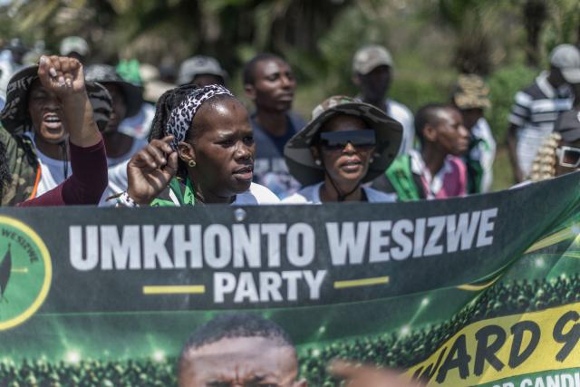 Supporters of the UmKhonto we Sizwe Party (MKP) sing and chant slogans during an election campaign mini rally in Umgababa, south of Durban on October 18, 2026, ahead of the country’s upcoming municipal elections. (Photo by RAJESH JANTILAL / AFP)
