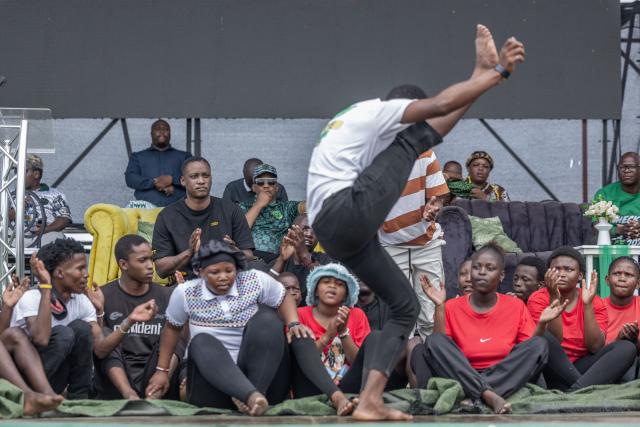 TOPSHOT - UmKhonto we Sizwe Party's (MKP) First President Duduzane Zuma watches a local group performing a Zulu dance during an election campaign mini rally in Umgababa, south of Durban on October 18, 2026, ahead of the country’s upcoming municipal elections. (Photo by RAJESH JANTILAL / AFP)