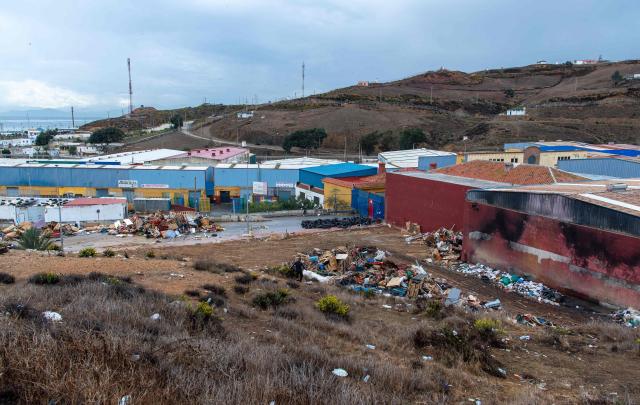 A picture taken on October 18, 2026 shows debris from a dismantled migrant settlement at the entrance to the Tarajal warehouses, in Spain's North African enclave of Ceuta. Scores of migrants remain sleeping rough in outlying neighborhoods of the city since the massive influx of tens of thousands of migrants from Morocco in late July, fueling tension in this Spanish North African enclave of some 80,000 inhabitants. Migrants are being transported by bus to police facilities, with minors taken to the National Police headquarters and adults transferred to the Tarajal Temporary Assistance Centre for Foreigners (CATE) for identification, registration and screening. (Photo by Antonio Sempere / AFP)