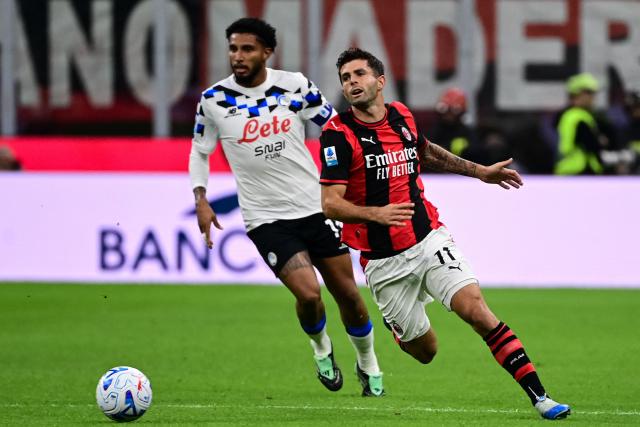 Atalanta's Brazilian midfielder #13 Ederson fights for the ball with AC Milan's American forward #11 Christian Pulisic during the Italian Serie A football match between AC Milan and Atalanta at the San Siro Stadium in Milan, Italy on October 18, 2026. (Photo by Piero CRUCIATTI / AFP)