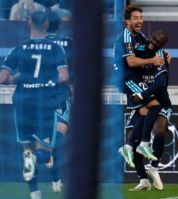 Paris FC's French midfielder #20 Maxime Lopez (C) celebrates scoring his team's second goal with Paris FC's French defender #19 Nhoa Sangui (R) during the French L1 football match between Paris FC and Stade Rennais FC at Jean-Bouin Stadium in Paris on October 18, 2026. (Photo by FRANCK FIFE / AFP)