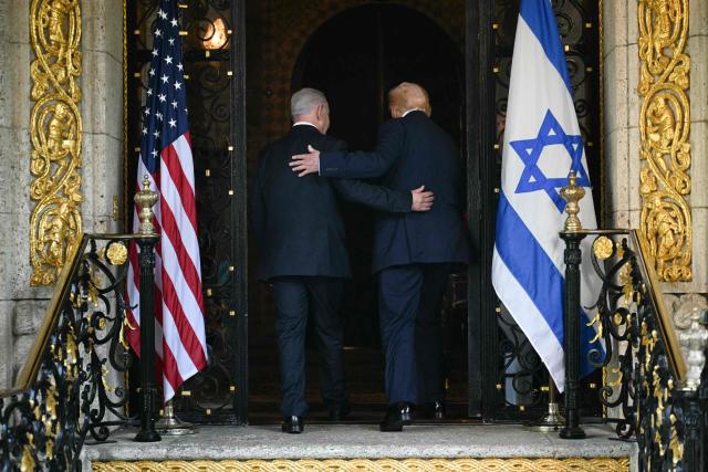 (FILES) US President Donald Trump (R) and Israeli Prime Minister Benjamin Netanyahu (L) walk inside after Netanyahu arrived at Trumps Mar-a-Lago residence in Palm Beach, Florida, on December 29, 2025. Trump on October 18, 2026, endorsed his ally Benjamin Netanyahu before Israel's close-fought parliamentary election on October 27 when the veteran prime minister will try to win a new mandate. "Bibi Netanyahu has been Strong, Brave, and Brilliant in the face of tremendous opposition, including that coming from even Israel, itself," Trump wrote on his Truth Social platform, using a common nickname for the Israeli leader. "This is the kind of Partner that the United States of America is demanding of Israel, a Country for which it has done so much. Please let this Letter serve to represent my Complete and Total Endorsement of Bibi Netanyahu in his upcoming Race for Re-Election as Prime Minister of Israel." (Photo by Jim WATSON / AFP)