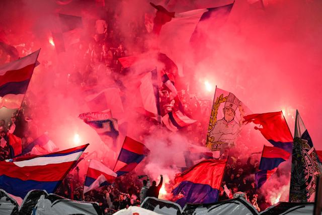 Lyon's supporters light up red smoke flares and wave flags ahead of the French L1 football match between Olympique Lyonnais (OL) and OGC Nice at the Groupama Stadium in Decines-Charpieu, central-eastern France, on October 18, 2026. (Photo by JEFF PACHOUD / AFP)