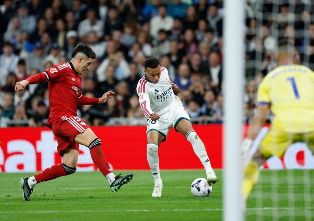 Real Madrid's French forward #10 Kylian Mbappe fights for the ball with Sevilla's Spanish defender #05 Andres Castrin during the Spanish league football match between Real Madrid CF and Sevilla FC at the Santiago Bernabeu stadium in Madrid on October 18, 2026. (Photo by Oscar DEL POZO / AFP)