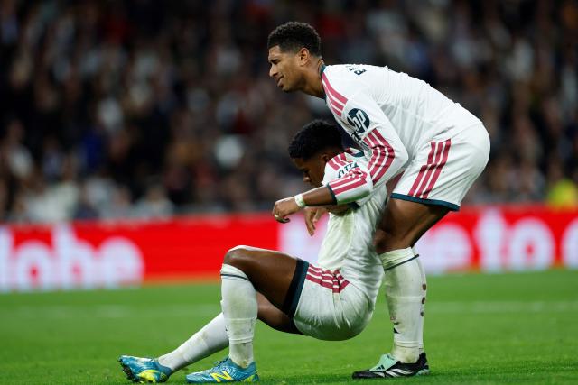 Real Madrid's English midfielder #05 Jude Bellingham lifts Real Madrid's Brazilian forward #09 Endrick during the Spanish league football match between Real Madrid CF and Sevilla FC at the Santiago Bernabeu stadium in Madrid on October 18, 2026. (Photo by Oscar DEL POZO / AFP)