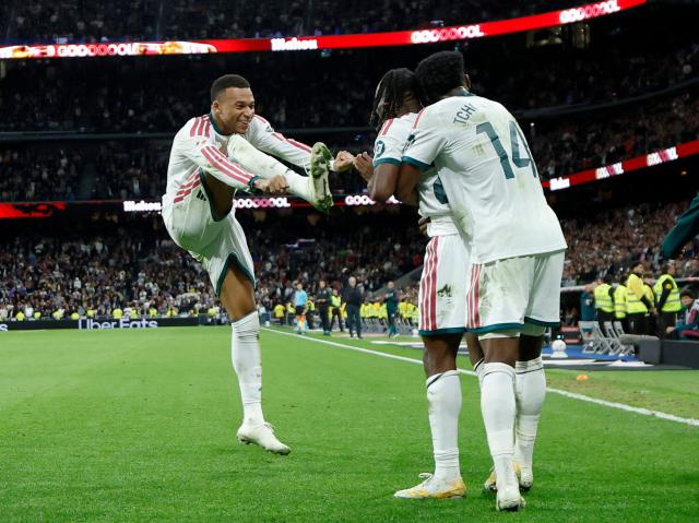 TOPSHOT - Real Madrid's Ivorian forward  #25 Yan Diomande celebrates scoring his team's fourth goal with Real Madrid's French forward #10 Kylian Mbappe (L) and Real Madrid's French midfielder #14 Aurelien Tchouameni (R) during the Spanish league football match between Real Madrid CF and Sevilla FC at the Santiago Bernabeu stadium in Madrid on October 18, 2026. (Photo by Oscar DEL POZO / AFP)
