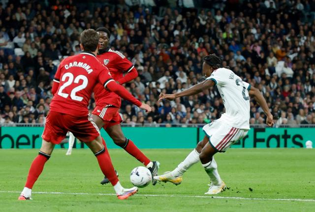 TOPSHOT - Real Madrid's Ivorian forward  #25 Yan Diomande scores his team's fourth goal during the Spanish league football match between Real Madrid CF and Sevilla FC at the Santiago Bernabeu stadium in Madrid on October 18, 2026. (Photo by Oscar DEL POZO / AFP)