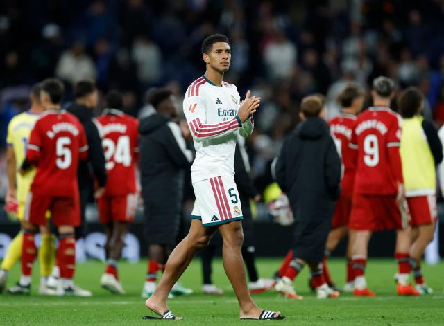 Real Madrid's English midfielder #05 Jude Bellingham applauds at the end of the Spanish league football match between Real Madrid CF and Sevilla FC at the Santiago Bernabeu stadium in Madrid on October 18, 2026. Real Madrid won 4-1. (Photo by Oscar DEL POZO / AFP)