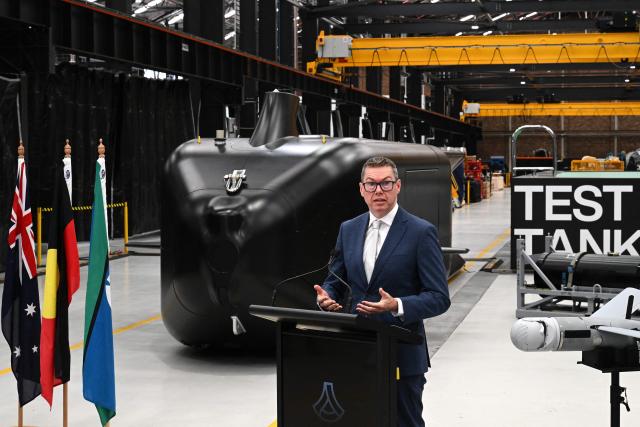 Australia’s Minister for Defence Industry, Pat Conroy, speaks to the media in front of the autonomous undersea vehicle Ghost Shark at an Anduril facility in Sydney on October 19, 2026, during the unveiling of three new capabilities for the company’s autonomous systems under AUKUS Pillar II. (Photo by Saeed KHAN / AFP)