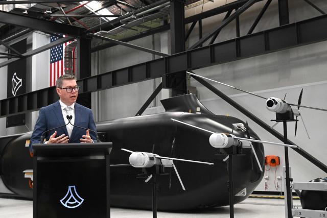 Australia’s Minister for Defence Industry, Pat Conroy, speaks to the media in front of the autonomous undersea vehicle Ghost Shark at an Anduril facility in Sydney on October 19, 2026, during the unveiling of three new capabilities for the company’s autonomous systems under AUKUS Pillar II. (Photo by Saeed KHAN / AFP)