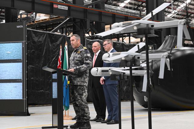 Royal Australian Navy Chief of Navy Vice Admiral Matthew Buckley (L) speaks to the media alongside Australia’s Minister for Defence Industry Pat Conroy (R), and Anduril Australia & Asia Pacific CEO and Executive Chairman David Goodrich at an Anduril facility in Sydney on October 19, 2026, during the unveiling of three new autonomous systems capabilities under AUKUS Pillar II. (Photo by Saeed KHAN / AFP)
