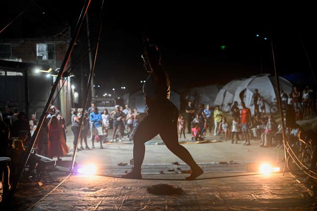 A member of the foundation Manzanoarte performs during the 6th Social Festival of Performing Arts in Playa Verde, Catia La Mar, La Guaira state, Venezuela, on October 18, 2026. The TET Center for Artistic Creation perform for survivors of two June 24, 2026, devastating earthquakes which killed more than 6,500 people. (Photo by Federico PARRA / AFP)