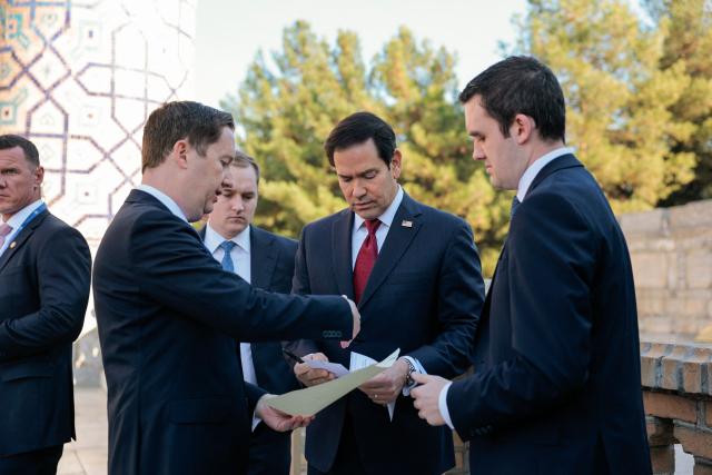 US Secretary of State Marco Rubio goes through notes with US Ambassador to India Sergio Gor (L) and an aide at Registan Square in Samarkand, Uzbekistan, on October 19, 2026. (Photo by Kylie Cooper / POOL / AFP)