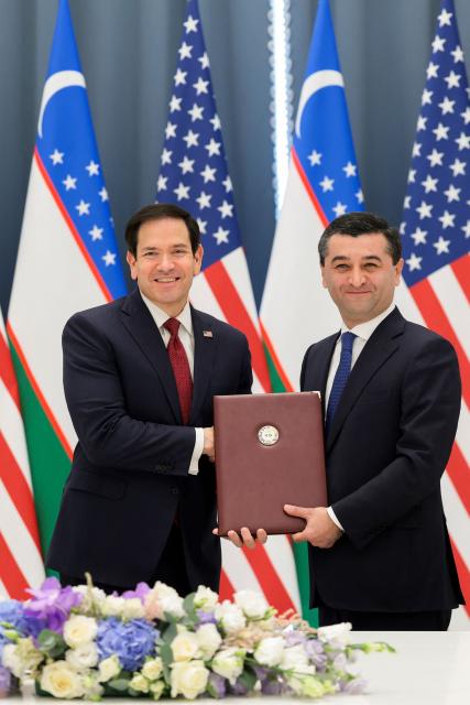 US Secretary of State Marco Rubio (L) and Uzbekistan's Foreign Minister Bakhtiyor Saidov pose for a picture holding the Artemis Accords during a signing ceremony at the Congress Center in Samarkand, Uzbekistan, on October 19, 2026. (Photo by Kylie Cooper / POOL / AFP)