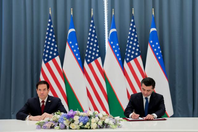 Uzbekistan's Foreign Minister Bakhtiyor Saidov signs the Artemis Accords next to US Secretary of State Marco Rubio during a signing ceremony at the Congress Center in Samarkand, Uzbekistan, on October 19, 2026. (Photo by Kylie Cooper / POOL / AFP)