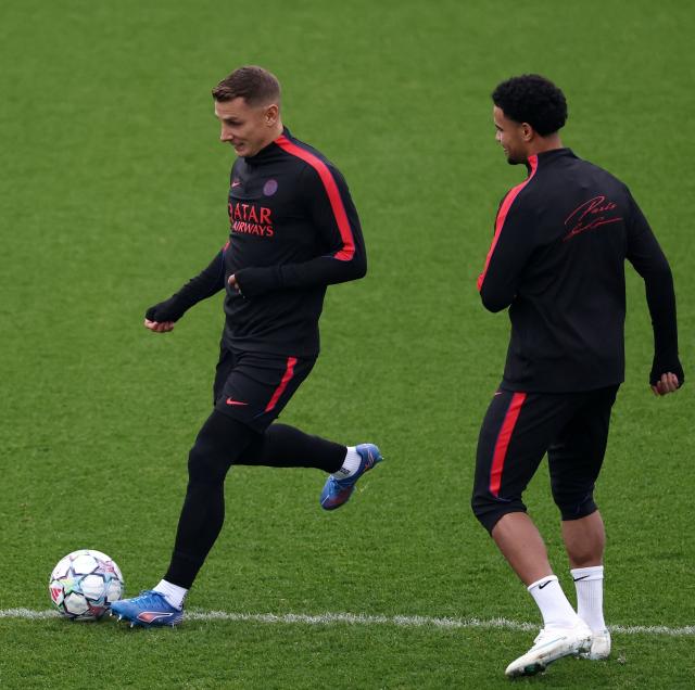 Paris Saint-Germain's French defender #12 Lucas Digne (L) runs with the ball in front Paris Saint-Germain's midfielder #33 Warren Zaire Emery during a training session at the Campus Paris Saint-Germain in Poissy, on October 19, 2026, on the eve of the UEFA Champions League first round day 3 football match against Barcelona. (Photo by FRANCK FIFE / AFP)