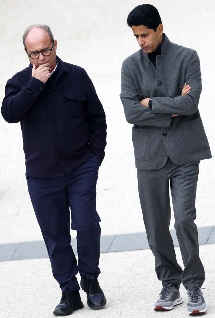 Paris Saint Germain's Portuguese Football Advisor Luis Campos (L) speaks with Paris Saint-Germain's Qatari president Nasser Al-Khelaïfi  on the sidelines of a training session at the Campus Paris Saint-Germain in Poissy, on October 19, 2026, on the eve of the UEFA Champions League first round day 3 football match against Barcelona. (Photo by FRANCK FIFE / AFP)