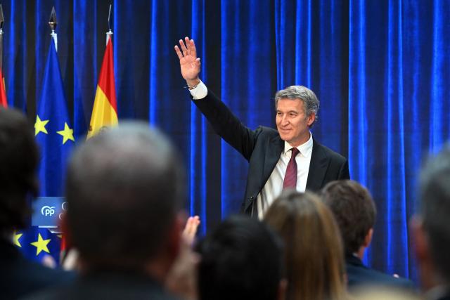 Leader of Partido Popular - PP (People's Party) Alberto Nunez Feijoo waves after presenting his 'Contract with Spain' political program ahead of the upcoming general election, in Madrid, on October 19, 2026. (Photo by JAVIER SORIANO / AFP)