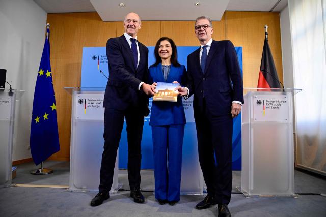 Deutsche Bank CEO Christian Sewing (L) and Siemens CEO Roland Busch (R) pose as they hand over a report by the "Made for Germany" initiative to German Economy and Energy Minister Katherina Reiche (C) at the Federal Ministry for Economic Affairs and Energy in Berlin on October 19, 2026. (Photo by John MACDOUGALL / AFP)