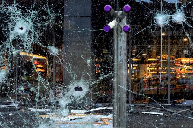 A person stands inside a damaged shopping mall following an air strike on  Kyiv on October 19, 2026, amid the Russian invasion of Ukraine. (Photo by Vladyslav Musiienko / AFP)