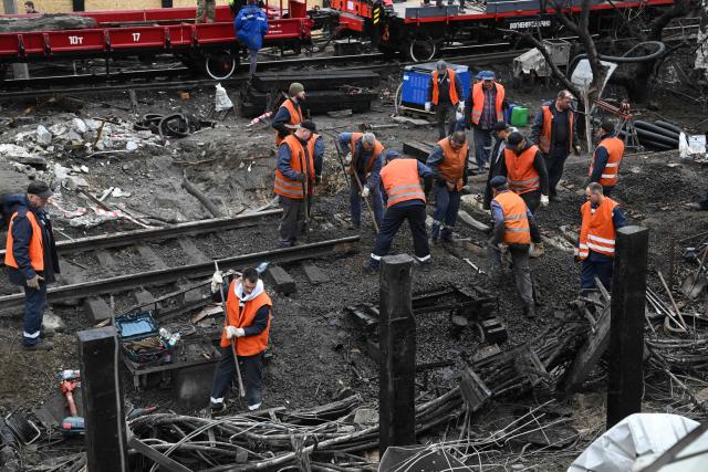 Workers clear the rubble from a metro station following a Russian ballistic missile strike on Kyiv on October 19, 2026, amid the Russian invasion of Ukraine. Ukraine did not receive an early warning from its international partners about incoming Russian ballistic strikes overnight that targeted energy facilities in Kyiv and the region, Ukrainian President Volodymyr Zelensky said on October 19, 2026. (Photo by Sergei SUPINSKY / AFP)