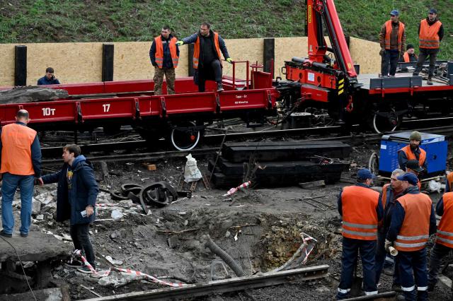 Workers clear the rubble from a metro station following a Russian ballistic missile strike on Kyiv on October 19, 2026, amid the Russian invasion of Ukraine. Ukraine did not receive an early warning from its international partners about incoming Russian ballistic strikes overnight that targeted energy facilities in Kyiv and the region, Ukrainian President Volodymyr Zelensky said on October 19, 2026. (Photo by Sergei SUPINSKY / AFP)