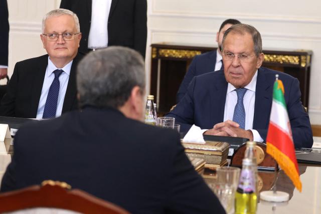 Russian Foreign Minister Sergey Lavrov (R) meets with Iran's Foreign Minister Abbas Araghchi (Back), in Tehran on October 19, 2026. Russian Foreign Minister Sergey Lavrov arrived in Iran on October 19, Russian media said, in his first visit since the outbreak of the Middle East war in February 2026, as Moscow seeks to play a mediating role. (Photo by ATTA KENARE / AFP)