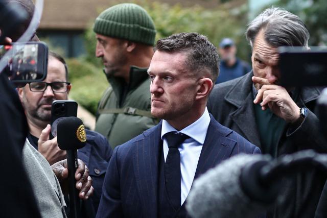 British far-right activist Tommy Robinson (C), real name Stephen Yaxley-Lennon, returns after lunch, at Southwark Crown Court in London on October 19, 2026, after being charged with harassment of two journalists in August 2024. (Photo by Henry NICHOLLS / AFP)