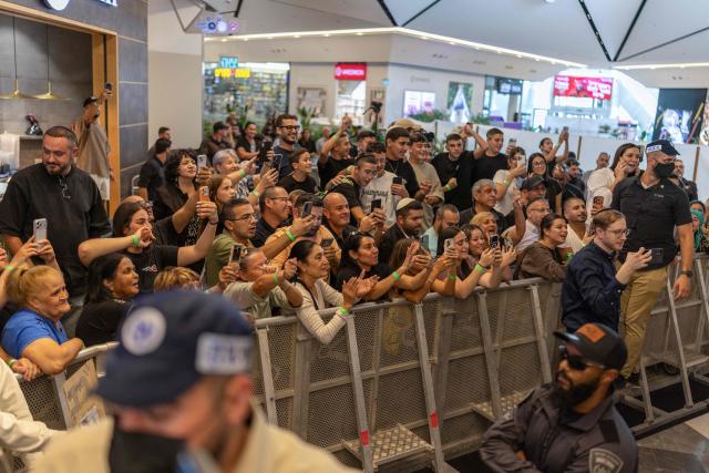 People take pictures as the Israeli prime minister meets with voters at a mall in Ramle on October 19, 2026. Israel heads to the polls on October 27 in its first election since the October 7, 2023 Hamas-led attack, in what is seen as a referendum on the prime minister. (Photo by ilia YEFIMOVICH / AFP)