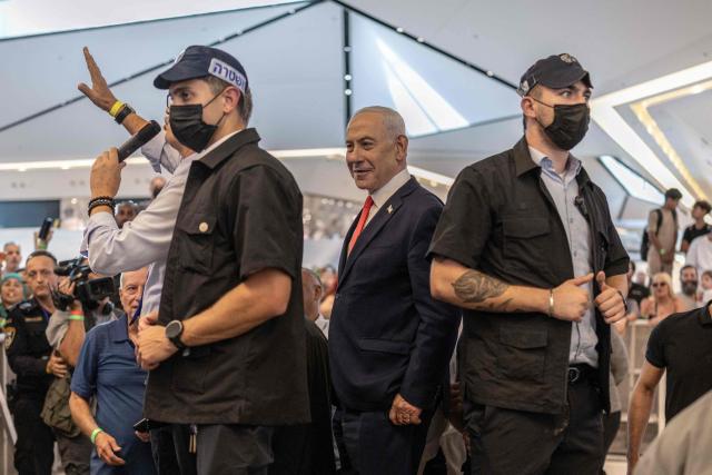 Israeli Prime Minister Benjamin Netanyahu stands amid security personnel as he meets with voters at a mall in Ramle on October 19, 2026. Israel heads to the polls on October 27 in its first election since the October 7, 2023 Hamas-led attack, in what is seen as a referendum on the prime minister. (Photo by ilia YEFIMOVICH / AFP)