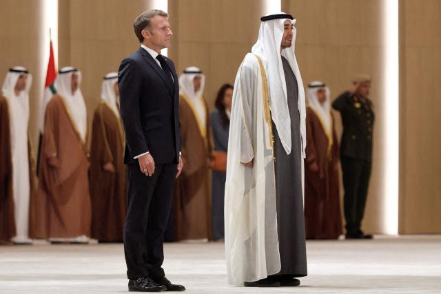 UAE President Sheikh Mohamed bin Zayed Al-Nahyan (C-R) receives France's President Emmanuel Macron (C-L) at Zayed International Airport in Abu Dhabi on October 19, 2026. (Photo by Benoit Tessier / POOL / AFP)