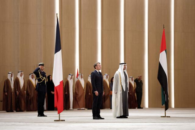 UAE President Sheikh Mohamed bin Zayed Al-Nahyan (C-R) receives France's President Emmanuel Macron (C-L) at Zayed International Airport in Abu Dhabi on October 19, 2026. (Photo by Benoit Tessier / POOL / AFP)