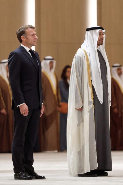 UAE President Sheikh Mohamed bin Zayed Al-Nahyan (C-R) receives France's President Emmanuel Macron (C-L) at Zayed International Airport in Abu Dhabi on October 19, 2026. (Photo by Benoit Tessier / POOL / AFP)