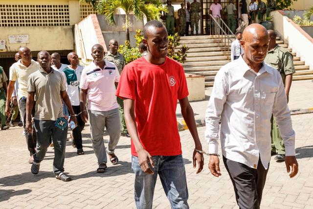 Self-proclaimed pastor Paul Mackenzie's (not pictured) co-accused are escorted for a break during their court appearance at the Mombasa Law Courts in Mombasa on October 19, 2026. A Mombasa court will deliver a long-awaited verdict on October 19 in the trial of a self-proclaimed Kenyan preacher and his associates, accused of murdering 191 people, mostly children, in an infamous starvation cult. Hundreds of bodies were discovered in 2023 inland from the Kenyan beach resort of Malindi, in what became known as the "Shakahola Forest Massacre". One of the world's worst cult-related tragedies made global headlines. (Photo by SIMON MAINA / AFP)