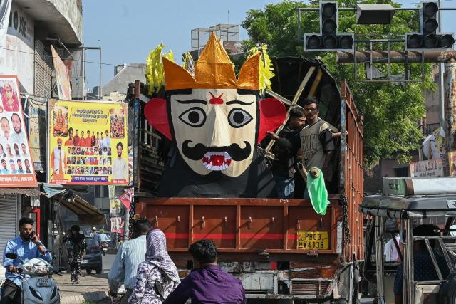 People transport an effigy of the Hindu demon King Ravana ahead of the 'Dussehra' festival in Amritsar on October 19, 2026. (Photo by Narinder NANU / AFP)