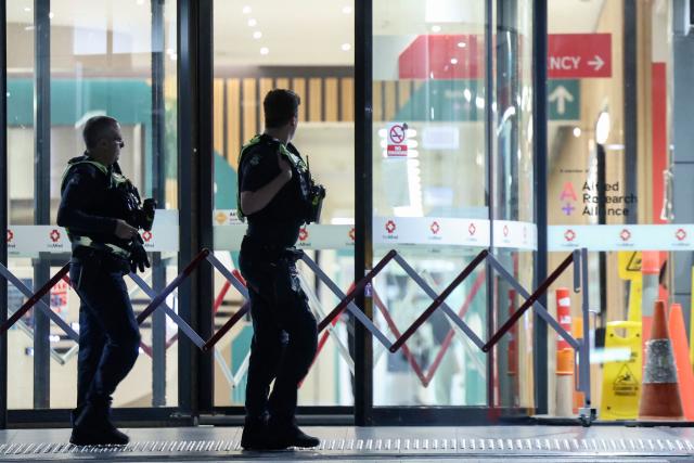 Police are seen outside Alfred Hospital, where Australian independent lawmaker Helen Haines was airlifted to for treatment with critical injuries after being struck by a car outside her office in Wangaratta, in Melbourne late on October 19, 2026. Haines was being treated in hospital for critical injuries on October 19 after being struck deliberately by a car in what officials described as a "violent" attack. (Photo by Martin KEEP / AFP)
