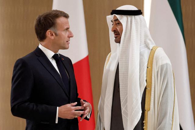UAE President Sheikh Mohamed bin Zayed Al-Nahyan (R) receives France's President Emmanuel Macron (L) at Abu Dhabi International Airport in Abu Dhabi on October 19, 2026. Macron began a Gulf tour on October 19 aimed at securing oil and diesel supplies in an effort to bring down prices, after a weekend of violent protests sparked by soaring living costs. (Photo by Benoit Tessier / POOL / AFP)