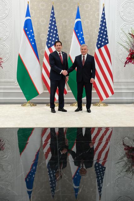 US Secretary of State Marco Rubio (L) and Uzbekistan's President Shavkat Mirziyoyev shake hands ahead of their meeting at the Congress Center in Samarkand on October 19, 2026. (Photo by Kylie Cooper / POOL / AFP)