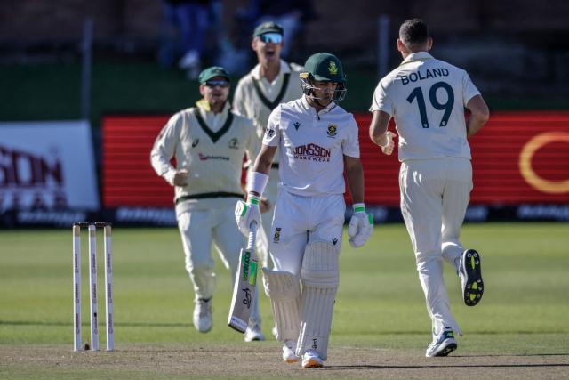 Australia's Scott Boland (R) celebrates after dismissing South Africa's Marques Ackerman (2nd R) on day two of the second Test match between South Africa and Australia at St Georges Park in Gqeberha on October 19, 2026. (Photo by Marco Longari / AFP)