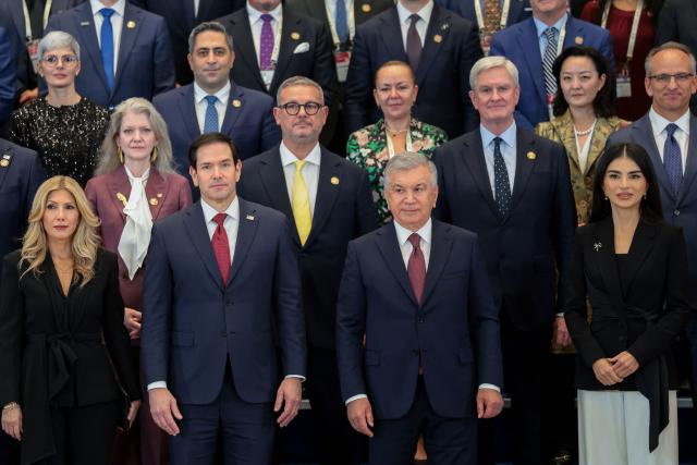 US Secretary of State Marco Rubio (front 2L) and his wife Jeanette Dousdebes Rubio (front L) alongside Uzbekistan's President Shavkat Mirziyoyev (front 2R) and his daughter and head of the Presidential Administration Saida Mirziyoyeva (front R), pose for a family photo with the American-Uzbek Business and Investment Council (AUBIC) at the Congress Center in Samarkand on October 19, 2026. (Photo by Kylie Cooper / POOL / AFP)