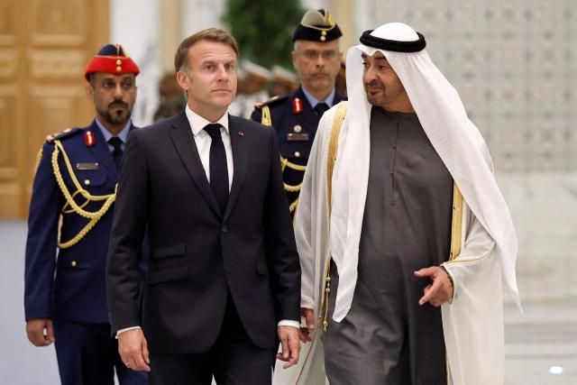 UAE President Sheikh Mohamed bin Zayed Al-Nahyan (R) receives France's President Emmanuel Macron (L) at Qasr al-Watan presidential palace in Abu Dhabi on October 19, 2026. Macron began a Gulf tour on October 19 aimed at securing oil and diesel supplies in an effort to bring down prices, after a weekend of violent protests sparked by soaring living costs. (Photo by Benoit Tessier / POOL / AFP)