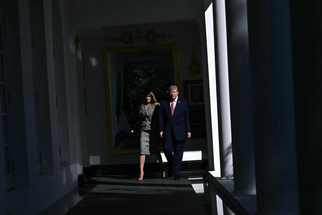 US President Donald Trump and First Lady Melania Trump arrive for an executive order signing ceremony in the Rose Garden of the White House in Washington, DC, on October 19, 2026. The executive order aims to a create a Women’s Health Division at the National Institutes of Health (NIH) and a White House Women’s Health Task Force. (Photo by Brendan SMIALOWSKI / AFP)