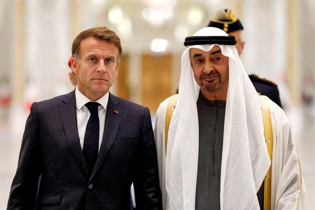 UAE President Sheikh Mohamed bin Zayed Al-Nahyan (R) receives France's President Emmanuel Macron (L) at Qasr al-Watan presidential palace in Abu Dhabi on October 19, 2026. Macron began a Gulf tour on October 19 aimed at securing oil and diesel supplies in an effort to bring down prices, after a weekend of violent protests sparked by soaring living costs. (Photo by Benoit Tessier / POOL / AFP)